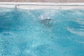 Underwater little girl boy jumping in swimming pool having fun swim on sunny day splashing water