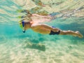 Underwater nature study, boy snorkeling in clear blue sea