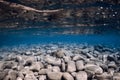 Underwater ocean with stones bottom, reflection and clear water