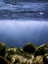 Underwater pebbles below water surface Royalty Free Stock Photo