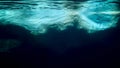 Underwater photo of big iceberg floating in cold ocean water
