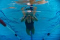 Underwater photo, girl swimming in a sports pool, front view Royalty Free Stock Photo
