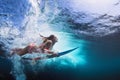 Underwater photo of girl with board dive under ocean wave