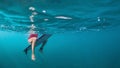 Underwater photo of surfer girl on surf board in ocean Royalty Free Stock Photo