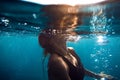 Underwater photo with woman in ocean and bubbles Royalty Free Stock Photo