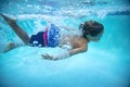 Underwater photo of a Young Boy swimmer in the Swimming Pool with Goggles. Royalty Free Stock Photo