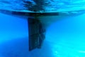 Underwater photography, selective focus. Underwater view of the propellers of a yacht in the blue water of the Aegean Sea.