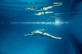 underwater picture of young swimmer in goggles exercising Royalty Free Stock Photo