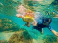 Underwater portrait of family snorkeling together at clear tropical ocean Royalty Free Stock Photo