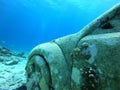 Underwater scene of a sunken car in the depths of the ocean floor.