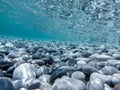 UNDERWATER sea level photo. Turquoise crystal clear water, pebbles of Agia Kyriaki beach in Kyparissi Laconia, Greece.