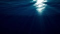 Underwater shot of ocean waves oscillate and flow with the rays of light creates a beautiful veil, consisting of