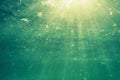 Underwater shot with sunrays and bubbles in deep tropical sea Royalty Free Stock Photo