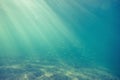 Underwater shot with sunrays and fish in deep tropical sea Royalty Free Stock Photo