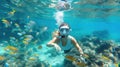Underwater shot of woman snorkeling in coral reef. Generative AI