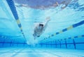 Underwater shot of young male athlete swimming in pool