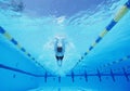 Underwater shot of young male athlete swimming in pool