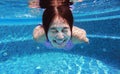 Underwater shot of young woman diving into the swimming pool Royalty Free Stock Photo