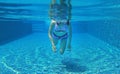 Underwater shot of young woman diving into the swimming pool Royalty Free Stock Photo