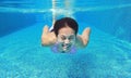 Underwater shot of young woman diving into the swimming pool Royalty Free Stock Photo