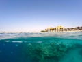 Underwater surface split view of coral fish and Egypt Royalty Free Stock Photo