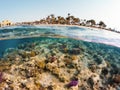 Underwater surface split view of coral fish and resort beach wit Royalty Free Stock Photo