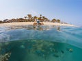 Underwater surface split view of coral fish and resort beach wit Royalty Free Stock Photo