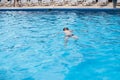 Underwater teen boy in the swimming pool with goggles in sunny day. Children Summer Fun. Kids water sport activity on Royalty Free Stock Photo