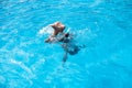 Underwater teen boy in the swimming pool with goggles in sunny day. Children Summer Fun. Kids water sport activity on Royalty Free Stock Photo