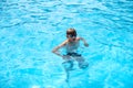 Underwater teen boy in the swimming pool with goggles in sunny day. Children Summer Fun. Kids water sport activity on Royalty Free Stock Photo