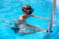 Underwater teen boy in the swimming pool with goggles in sunny day. Children Summer Fun. Kids water sport activity on Royalty Free Stock Photo