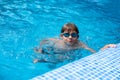 Underwater teen boy in the swimming pool with goggles in sunny day. Children Summer Fun. Kids water sport activity on Royalty Free Stock Photo