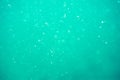 Underwater turquoise texture in ocean. Bubbles in tropical sea Royalty Free Stock Photo