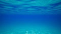 Underwater view of clear blue ocean water with sunlight filtering through the surface creating rippling patterns Royalty Free Stock Photo