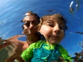 Underwater view of a father and her daughter with distorted face Royalty Free Stock Photo