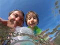 Underwater view of a father and her daughter with distorted face Royalty Free Stock Photo