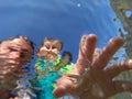 Underwater view of a father and her daughter with distorted face Royalty Free Stock Photo