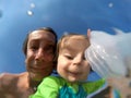 Underwater view of a father and her daughter with distorted face Royalty Free Stock Photo