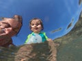 Underwater view of a father and her daughter with distorted face Royalty Free Stock Photo