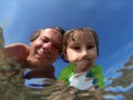 Underwater view of a father and her daughter with distorted face Royalty Free Stock Photo