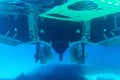 Underwater view of the propellers of a yacht in the blue water of the Aegean Sea. Underwater photography, selective focus.