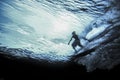 Underwater view of surfer riding wave