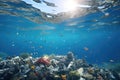 Underwater view of a tropical coral reef with lots of fish and plastic trash, Plastic waste in the sea. Environmental pollution