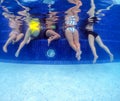 Underwater view of young women having fun in hotel pool. Concept of vacation and bachelorette pool party