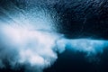 Underwater wave with foam. Blue powerful wave in sea