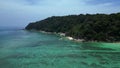 Undiscovered beach palm trees smooth rocks. Great aerial top view flight drone