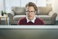 Undivided attention gets things done. a young businessman using a computer at his desk in a modern office. Royalty Free Stock Photo