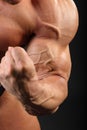 Undressed bodybuilder demonstrates biceps Royalty Free Stock Photo