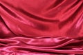 Undulating folds of the fabric of dark red silk Royalty Free Stock Photo