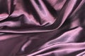 Undulating folds of the fabric of purple silk